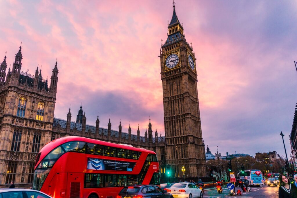 This image displays street in london, uk with big ben and red double decker bus. In article about the most unique boutique hotels in london, with taste of rocknroll and art.